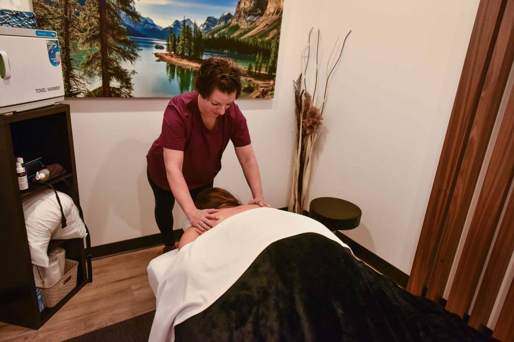 Jessica Koch with Patient | Complete Health | Chiropractic & Wellness Center | SW Calgary