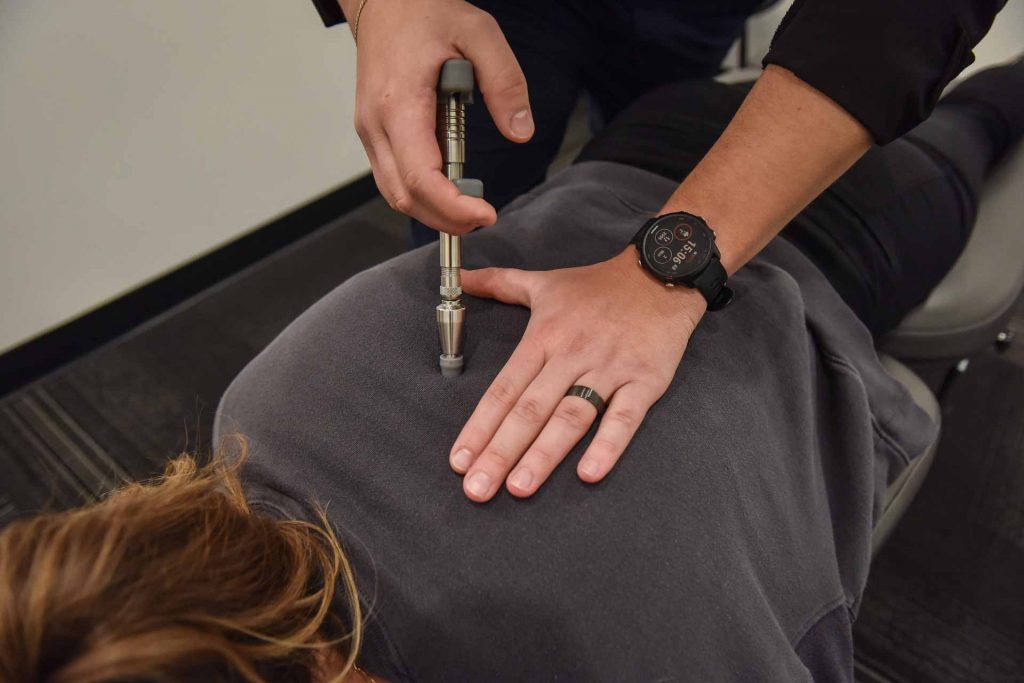 Dr. Carson Penner with Patient | Complete Health | Chiropractic & Wellness Clinic | SW Calgary